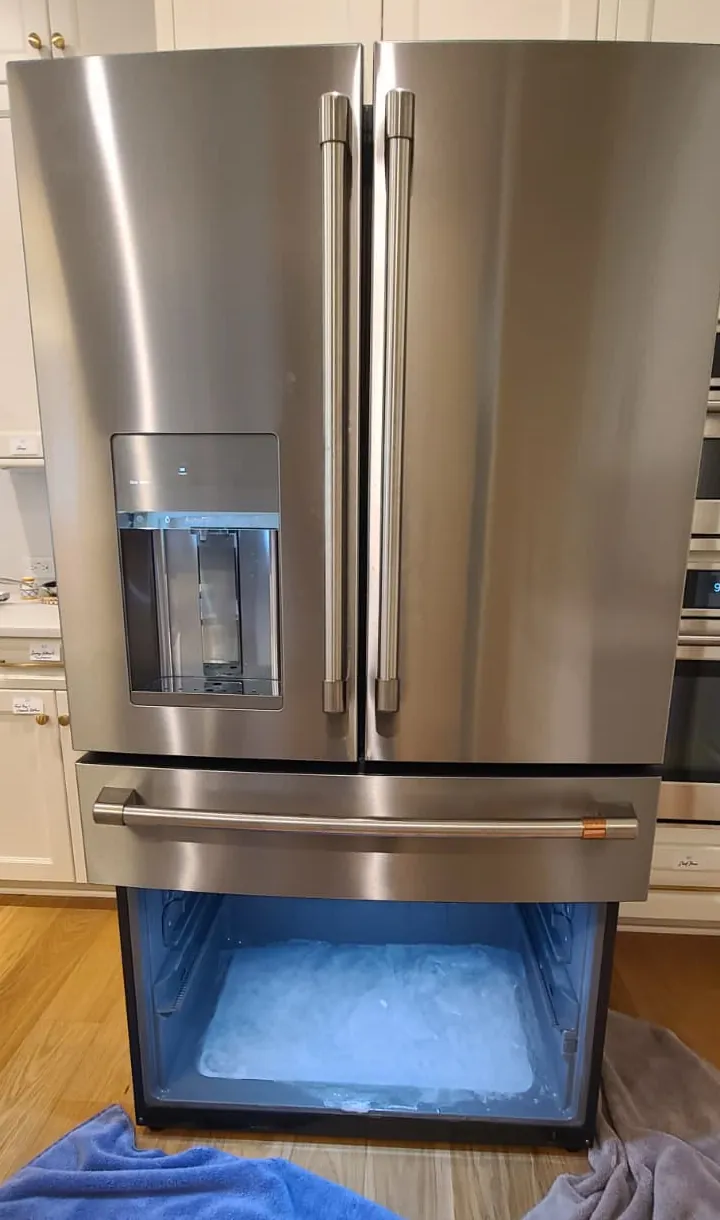 Café refrigerator freezer ice buildup before drain repair in Carmel